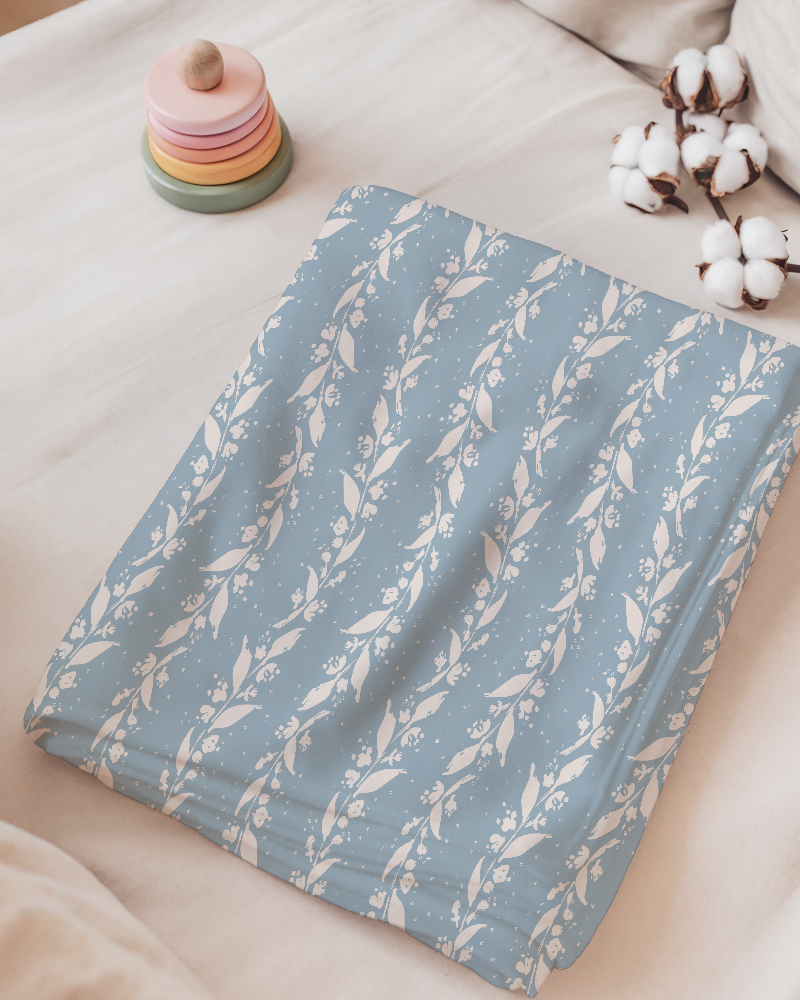 Atelier Botanique Heritage Garden botanical pattern on a soft blue blanket