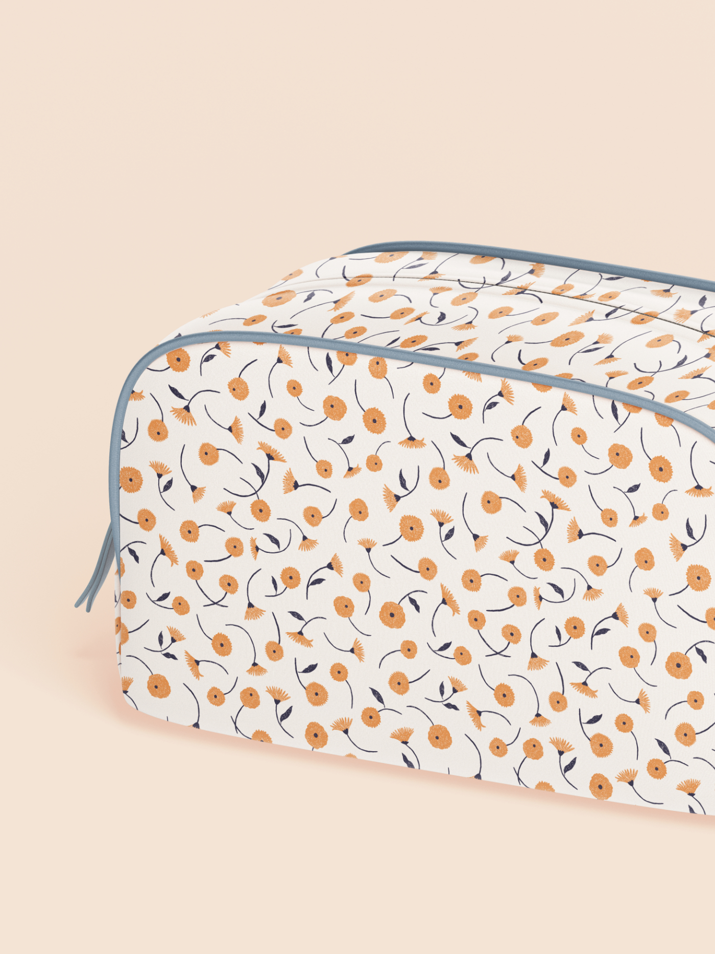 Cosmetic bag featuring the Dancing Blooms pattern with delicate orange flowers and dark blue stems on an ivory background.