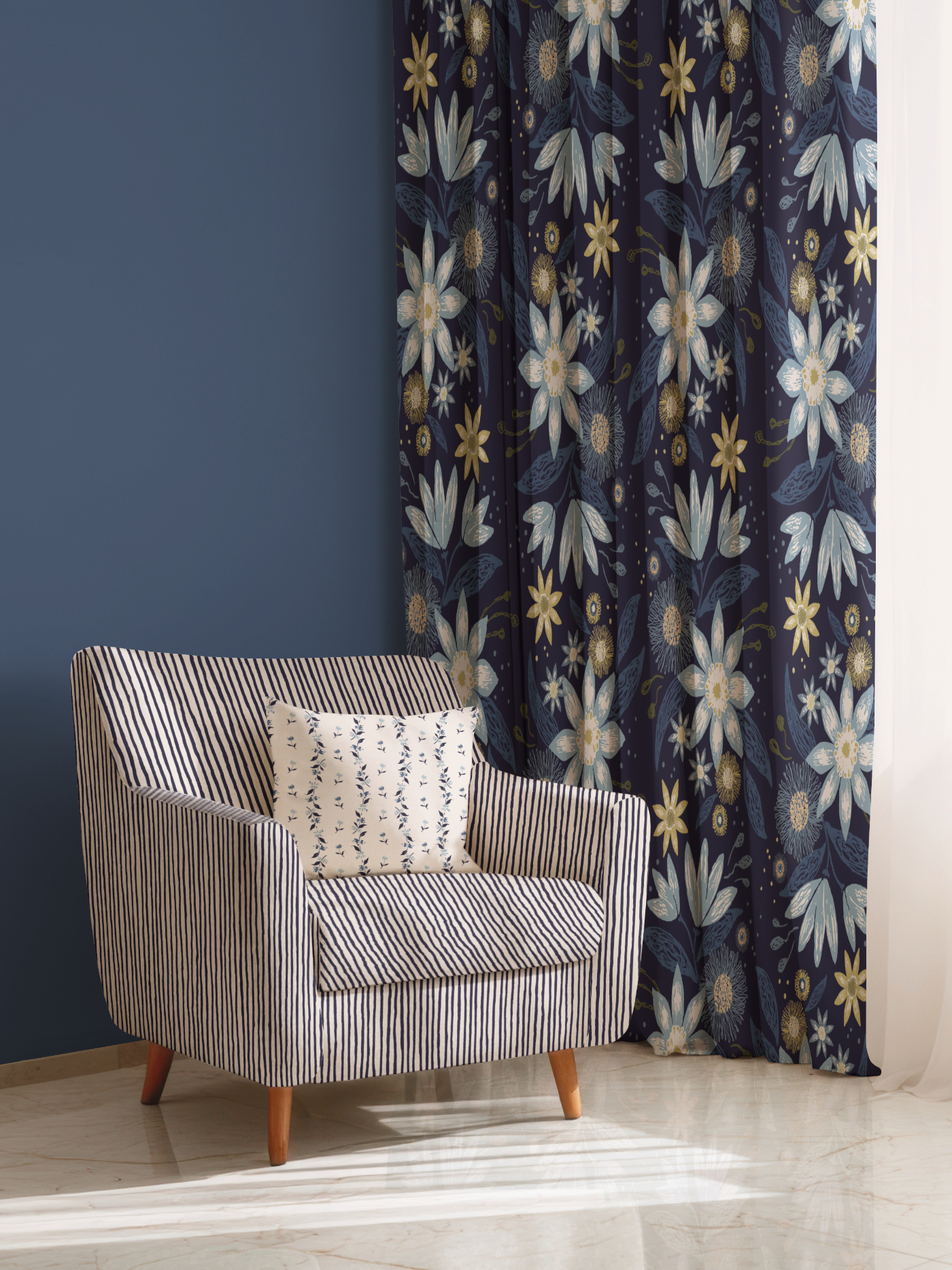 Elegant armchair upholstered in a blue and ivory striped pattern, paired with a floral cushion and framed by Botanical Reverie floral curtains in the Heritage Garden colorway.